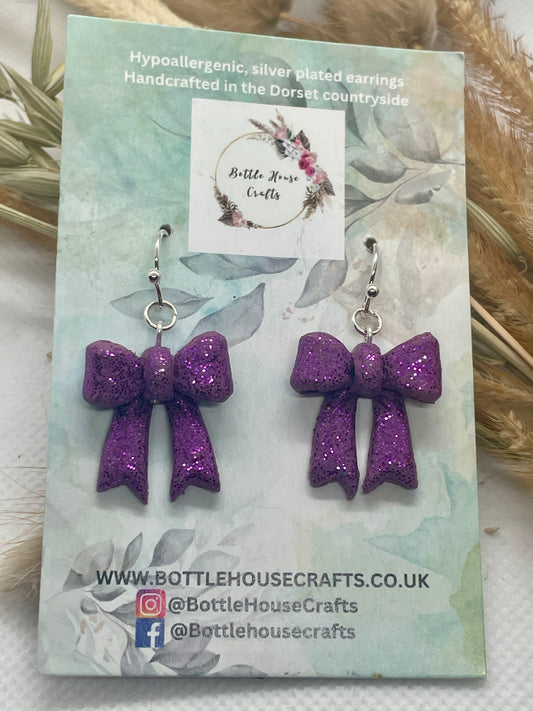 Larger purple sparkle winter bow earrings