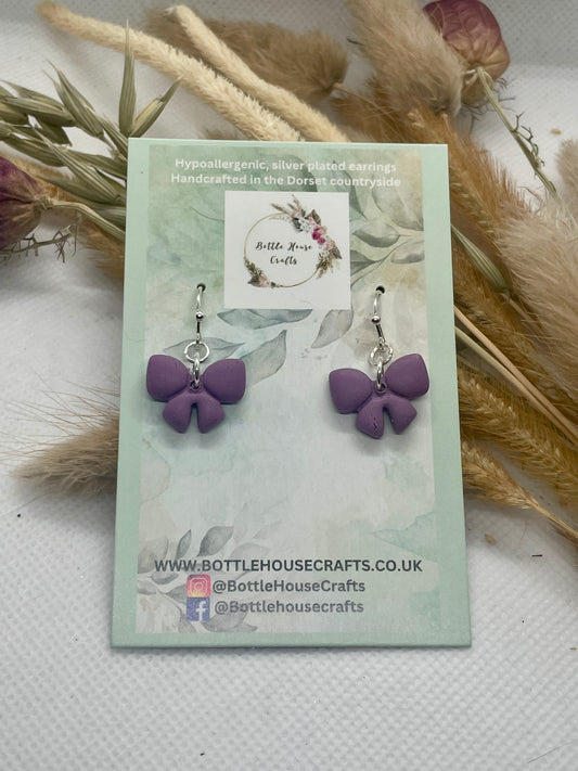 Small purple winter bow earrings