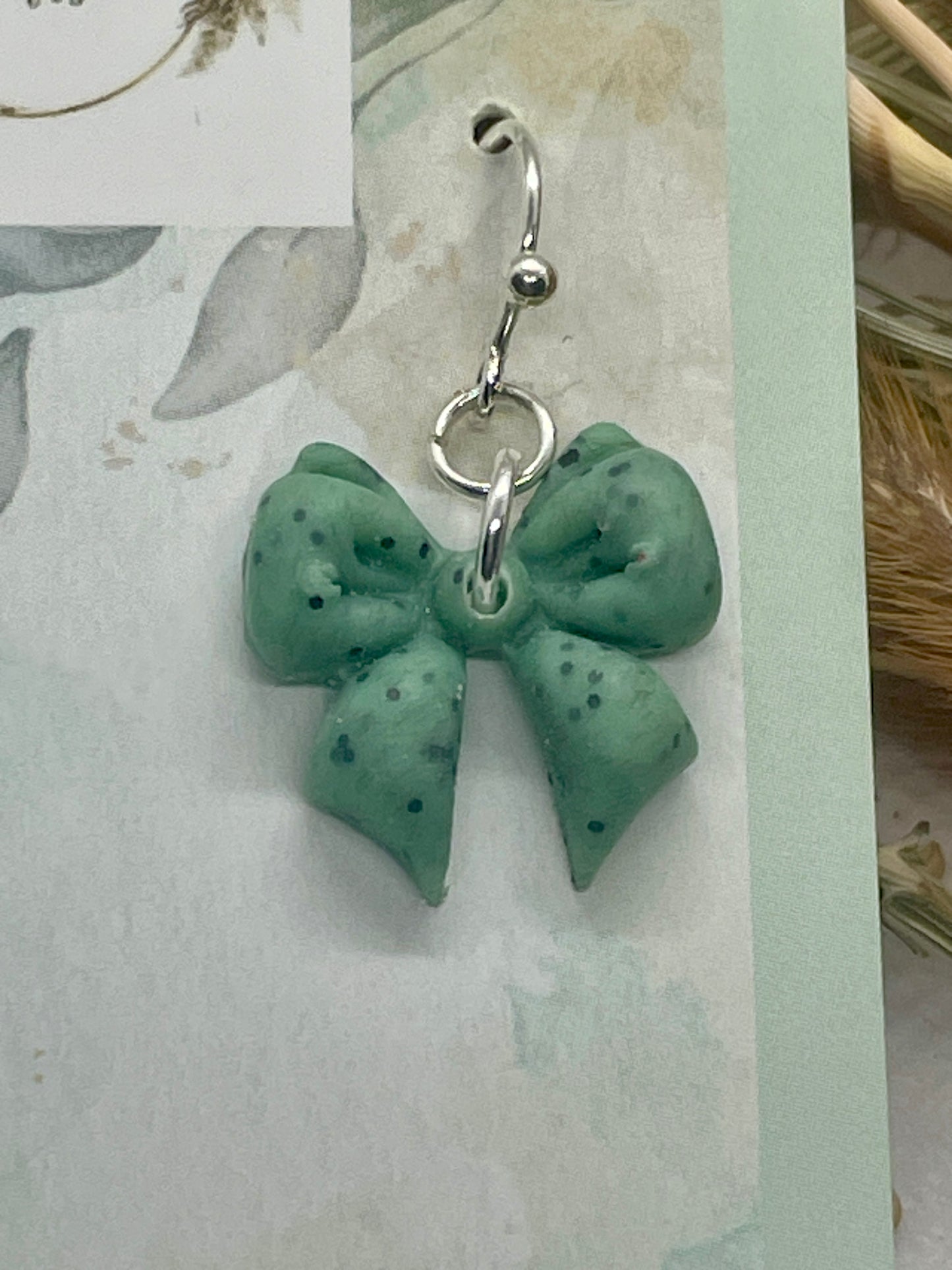 Sage green speckle midi winter bow earrings