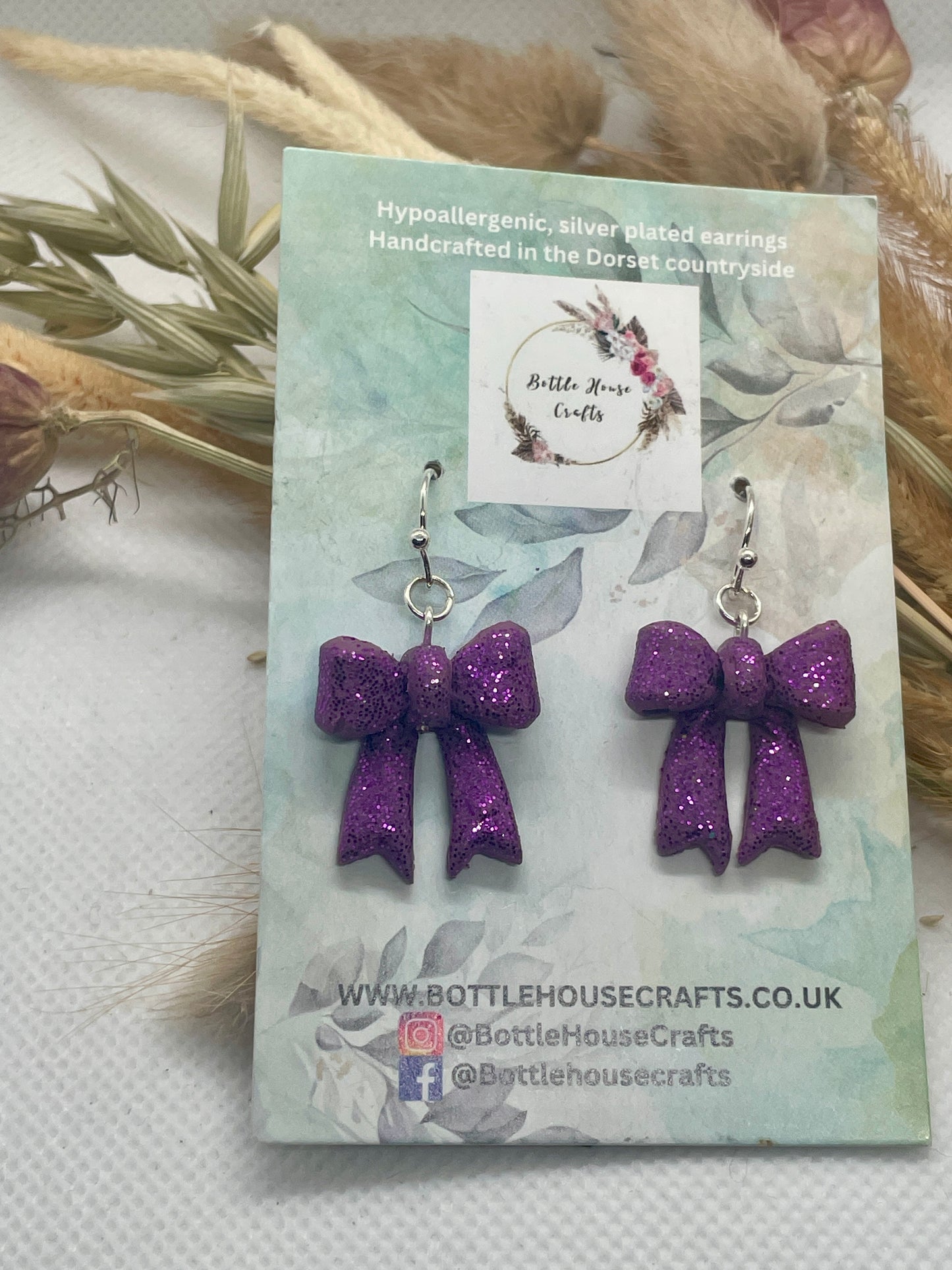 Larger purple sparkle winter bow earrings