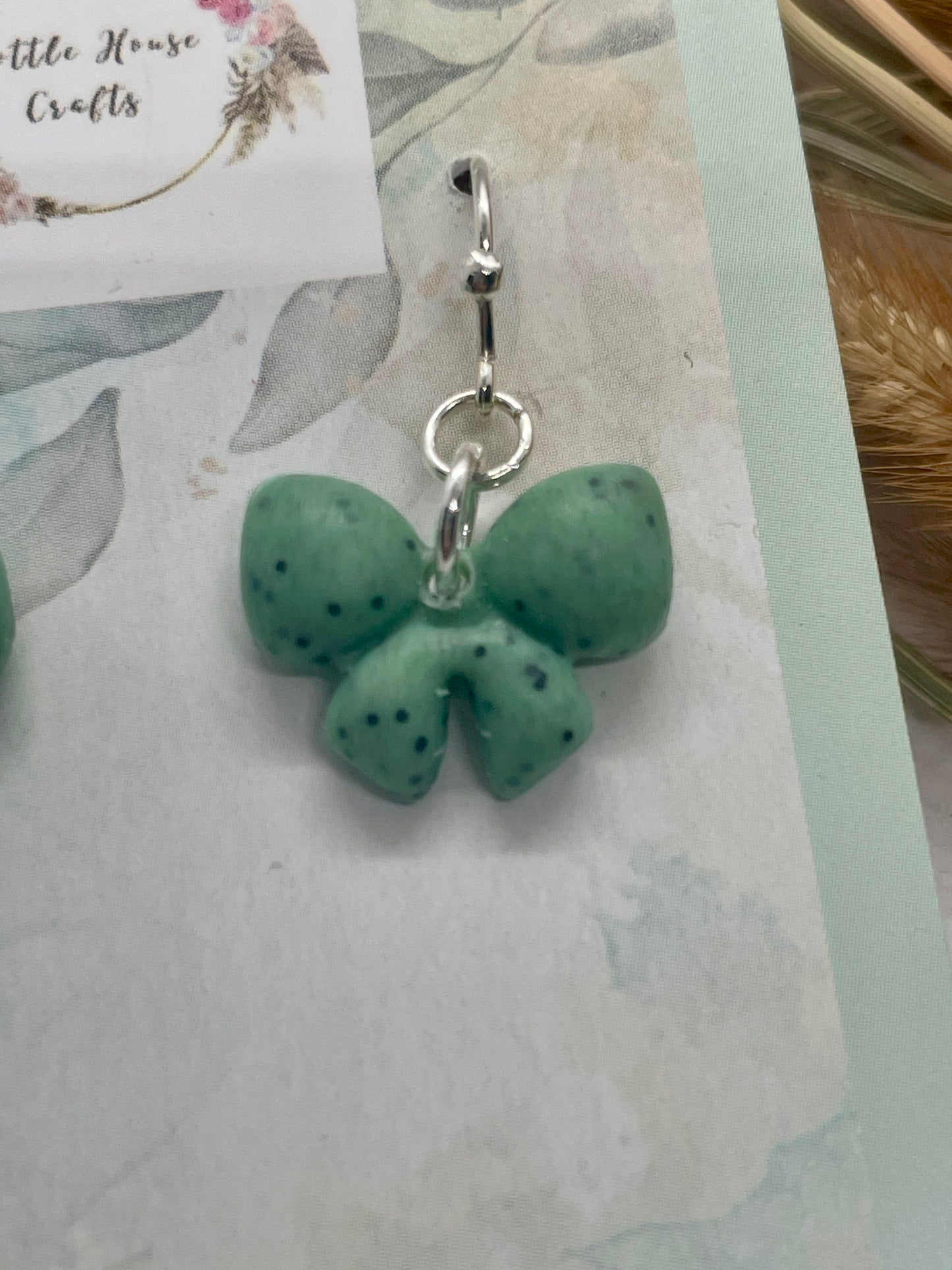 Sage green speckle mini winter bow earrings