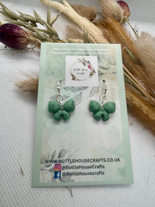 Sage green speckle mini winter bow earrings