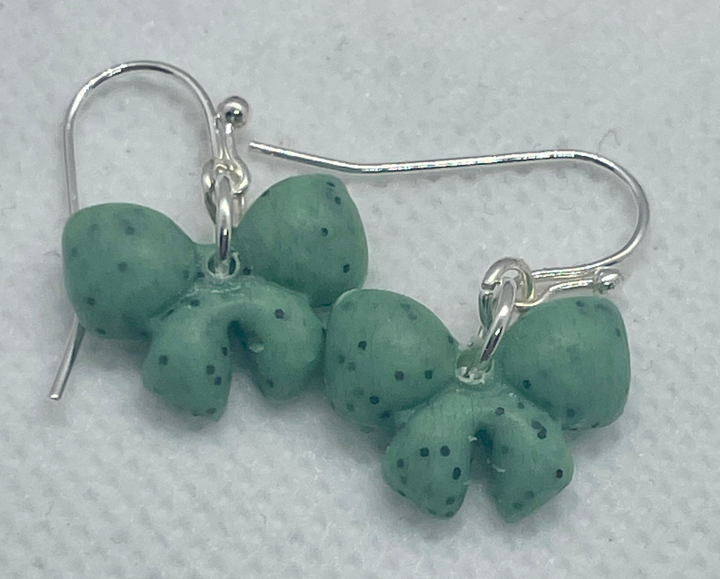 Sage green speckle mini winter bow earrings