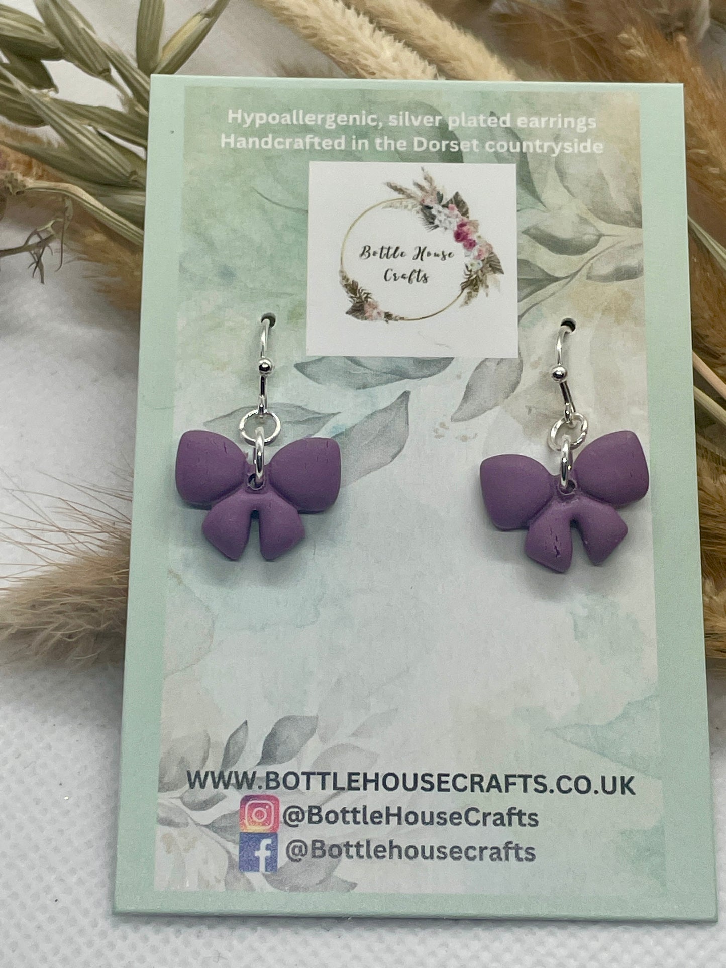 Small purple winter bow earrings