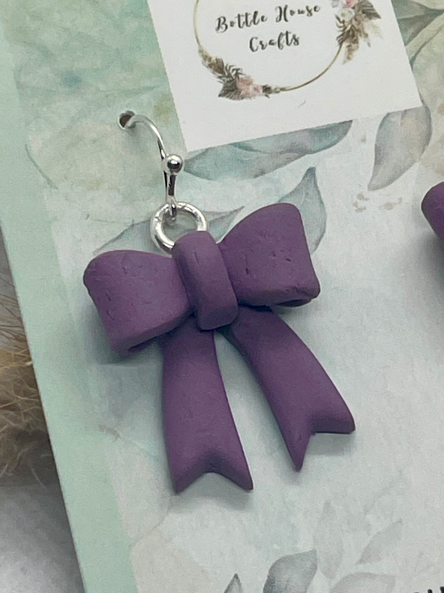 Larger purple winter bow earrings