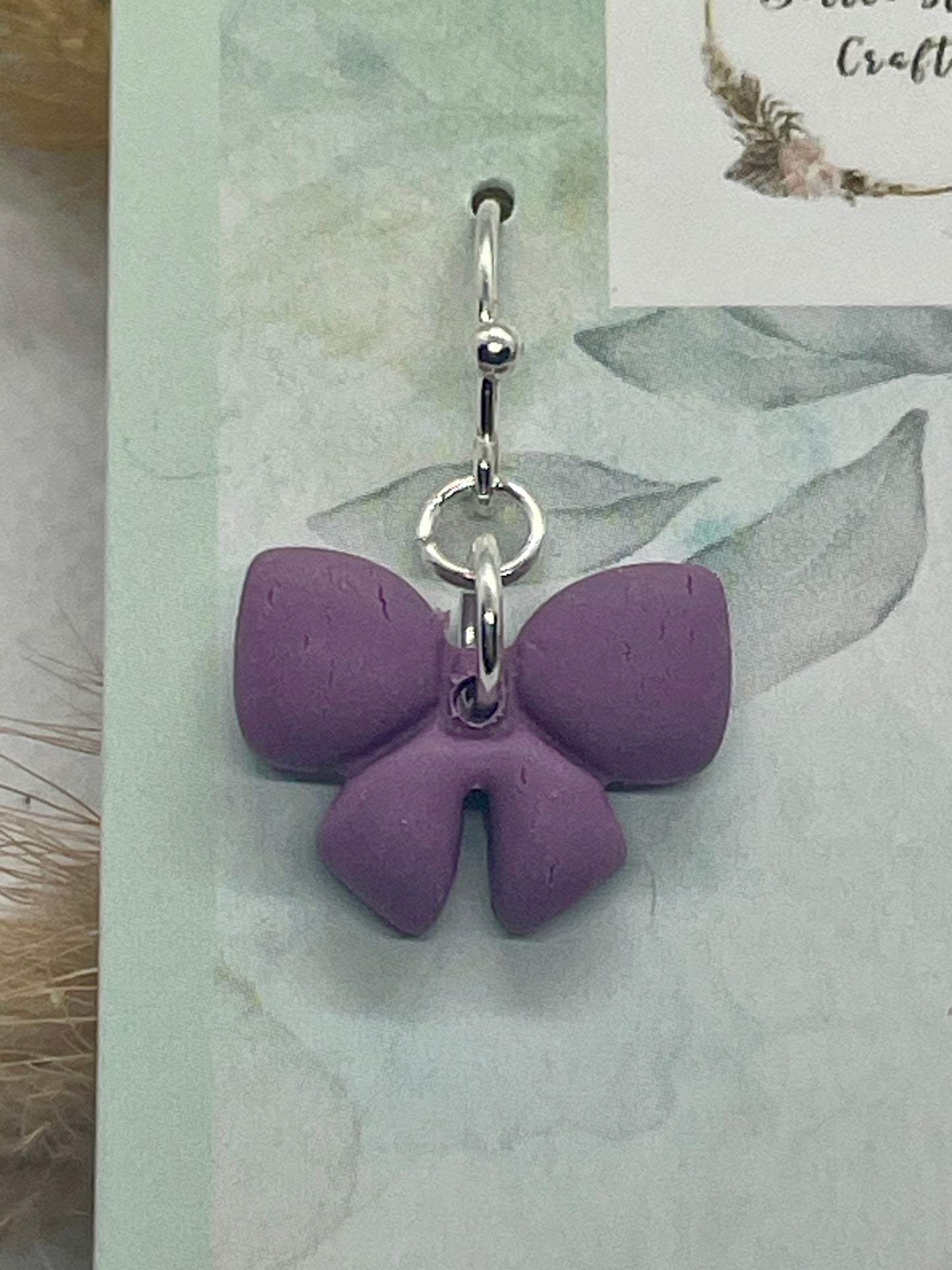 Small purple winter bow earrings