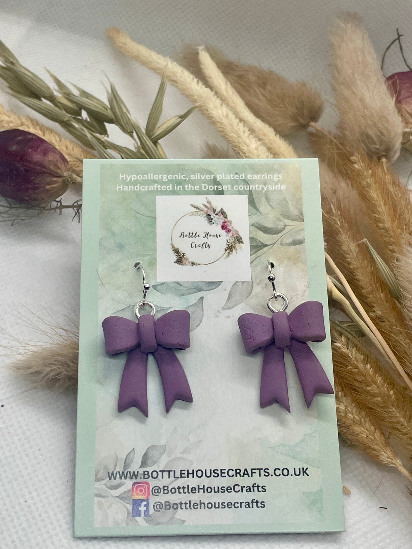 Larger purple winter bow earrings