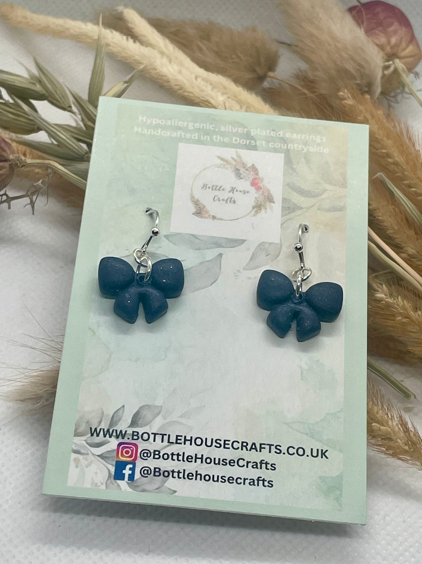 Small navy blue winter bow earrings