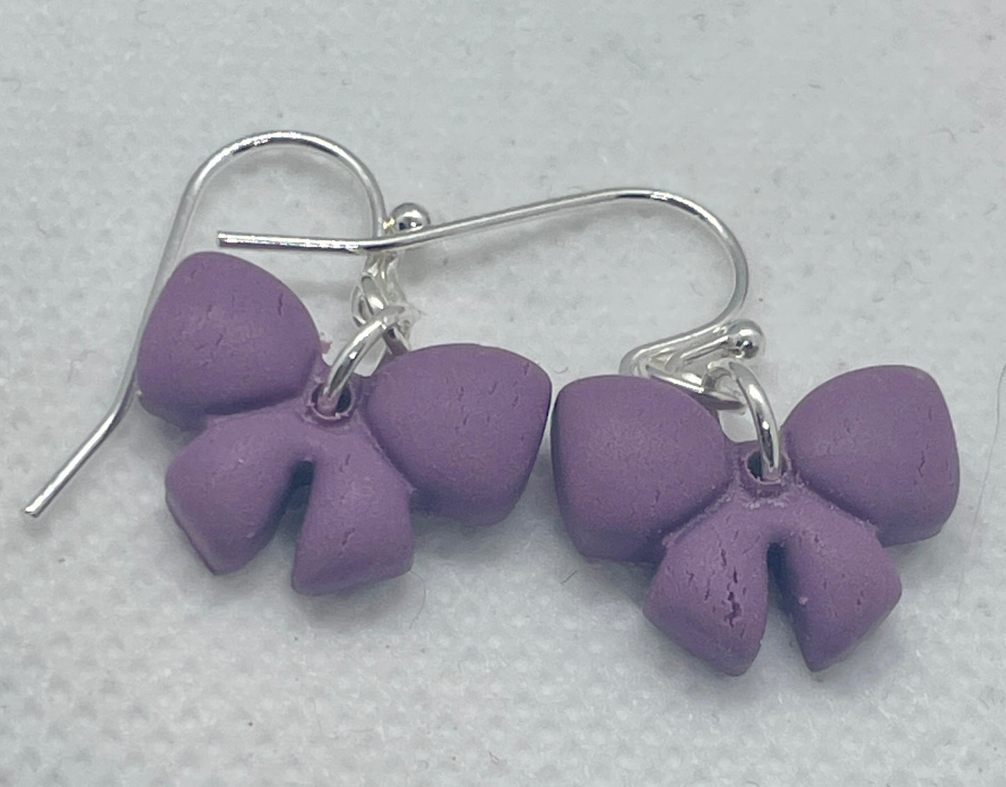 Small purple winter bow earrings