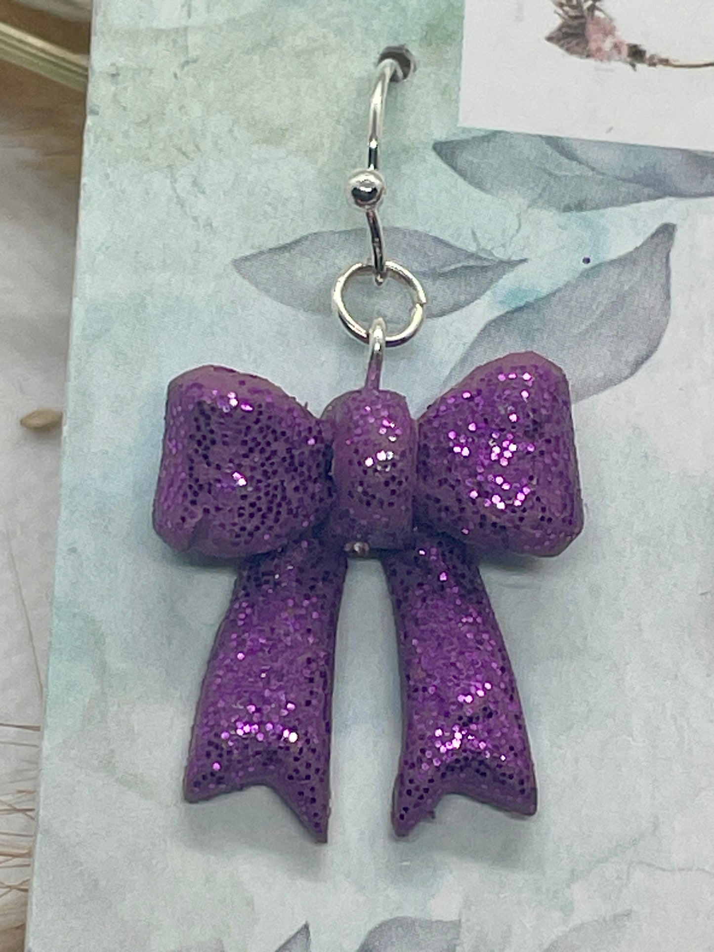 Larger purple sparkle winter bow earrings